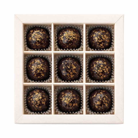 9er Pralinen-Box Latte Macchiato Eierpunsch – Draufsicht auf 9 Premium-Kaffee-Pralinen aus dunkler Schokolade mit Goldglitter, exklusives alkoholisches Geschenk